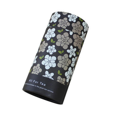 Eco-friendly matte kraft paper black cylindrical tea packaging, decorated with floral patterns
